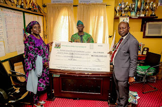 NPA spokesperson at Tin Can Island Port, Mrs Auwal Usman (left) Mr Sola Adesanwo, Head Corporate and Strategic Communication, presenting a cheque to the Principal of the College, Mr Ibitoye Olusegun