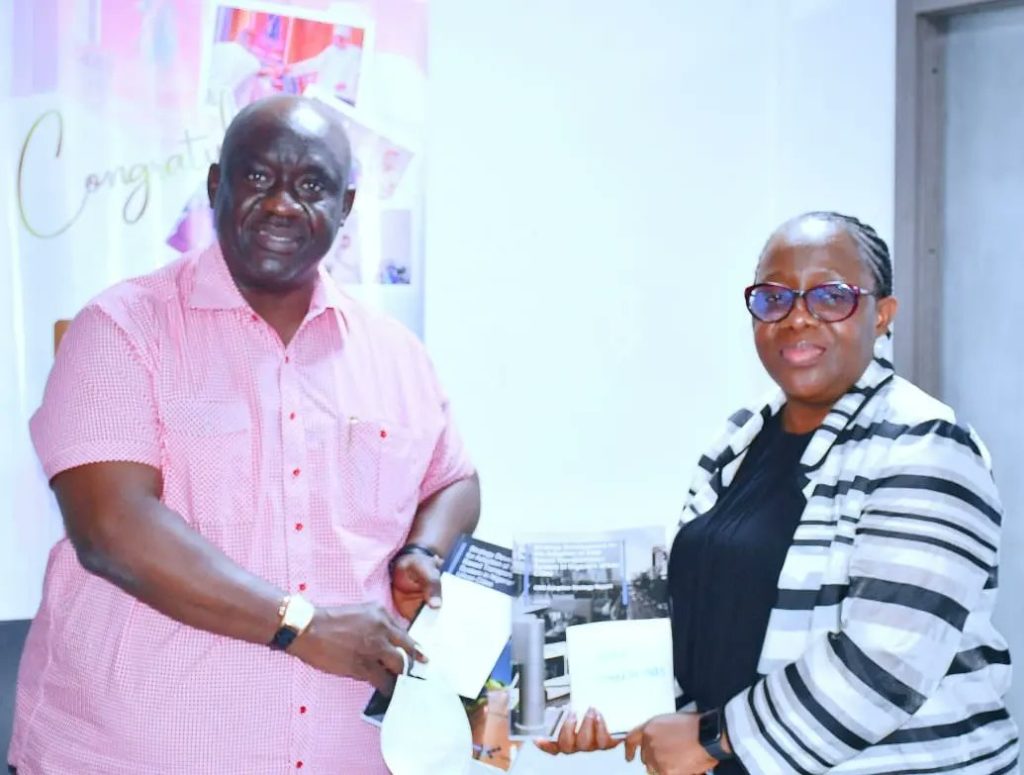 Minister of State for Transportation, Ademola Adegoroye (left) receiving the CNG Report from the Permanent Secretary of the ministry, Dr Magdalene Ajani on Tuesday in Abuja.