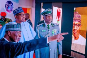 L-R: Comptroller General of customs, Col Hameed Ali pointing out some features of the new customs house to President Muhammadu Buhari while Deputy Comptroller General of customs, Wale Adeniyi watches on Tuesday
