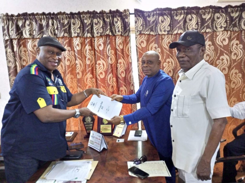 Chairman of Lagos State Wharf Landing Fee Collecting Authority, Hon Adegboyega Salvador (left) presenting the official gazettes and relevant laws backing the agency to President of IMAN, Chief Kingsley Chikezie while the Deputy Chairman South West of IMAN, Chief Austin Kelly looks on when IMAN visited the authority in Apapa Lagos on Monday