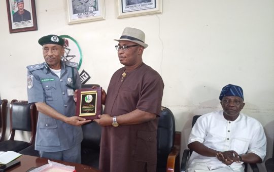 Customs Area Controller of the Murtala Muhammed Area Command (MMAC Cargo), Comptroller Sambo Dangaladima (left) exchanging souvenir with the Acting President of ANLCA, Dr Kayode Farinto while the National Secretary, Alhaji Babatunde Mukaila looks on during ANLCA working visits to the Lagos Airport on Monday