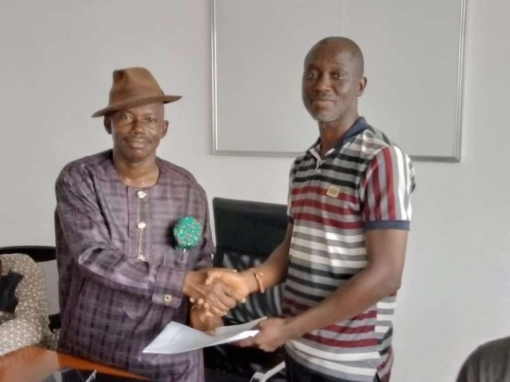 Pastor John Iwori (left) handing over the reigns of MARAN to Mr Gboyega Oni of Port News in Apapa on Thursday