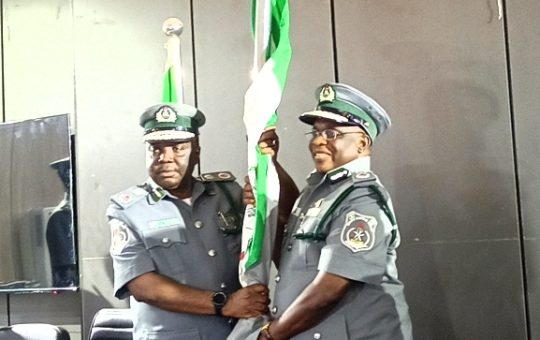 New Apapa customs Area Controller, Compt Auwal Mohammed (left) receiving the flag of office from ACG Yusuf Malanta