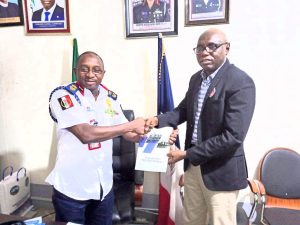 National Cordinator of PSTT, Comrade Moses Fadipe (right) presenting the Nigerian Ports Process Manual (NPPM) to the Lagos Commandant of NSCDC, Usman Alfadarai during a courtesy visit to the NSCDC office, Ikeja on Tuesday