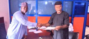 Secretary of ANLCA's Association Electoral Committee (ASECO) Alhaji Mustapha Yakubu (left) presenting nomination form purchased on behalf of Chief Emenike Nwokeoji to Barr Raymond Oyimba who led other group of friends to the ANLCA National Secretariat on Wednesday