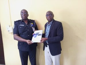 Western Port Authority Police Commissioner, Jonathan Towuru (left) receiving the Ports Process Manual from Cordinator of PSTT, Mr Moses Fadipe