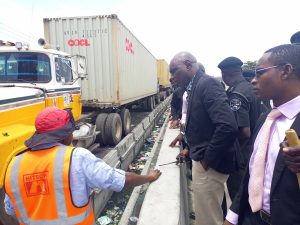 PSTT Coordinator, Moses Fadipe (right) during a field exercise, speaking with HITECH Construction officials