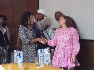 MWUN General Vice President Ms. Funmi Fasan (left) presents souvenirs to the visiting ITF team