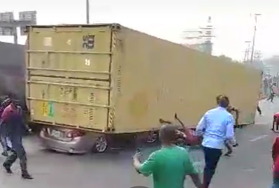 Driver Escapes Death by Whiskers, As 40ft Container Falls Ontop Toyota ...